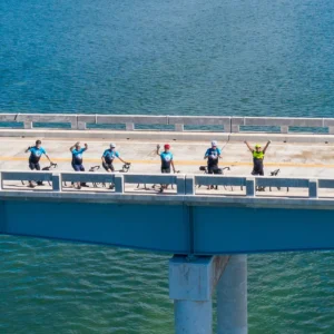 Cyclists waving from the seven-mile bridge from one of the Key West cycling trips