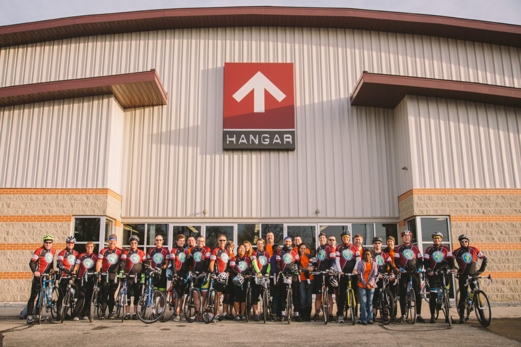 Midwest Bike Ride cyclists lined up in front of “The Hangar” at FBC Vandalia