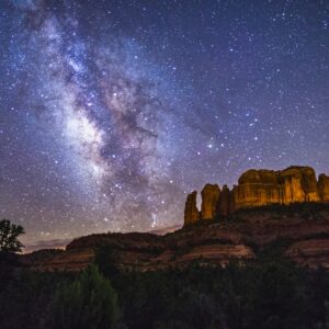 Milky Way over Cathedral Rock

More:

 View of the Milky Way over Cathedral Rock, seen from the Cathedral Rock Trailhead on Back O' Beyond Road, Sedona, Arizona.Cathedral Rock is a prominent rock formation located between Sedona and the Village of Oak Creek, Arizona. Both towns are certified International Dark Sky Communities, abiding by lighting ordinances that help protect northern Arizona's dark skies for local observatories, astronomers, and star gazers. The Milky Way is visible with the naked eye throughout northern Arizona, aided by Dark Sky ordinances, low population density, and extensive public lands. Many towns and National Parks participate in the program.Credit: U.S. Forest Service Coconino National Forest. Learn more about the Coconino National Forest and the International Dark Sky Association. Original public domain image from Flickr.